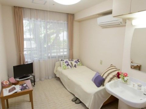 壁面はアイボリーで床面は段差がない。腰高窓があり日当たりも良好で明るい。エアコン、鏡付き洗面台も完備している。