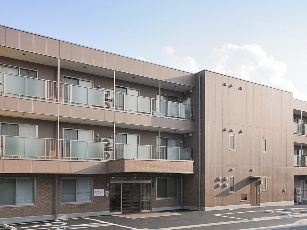 一般的なマンションのような外観で、落ち着いた色合いのホーム