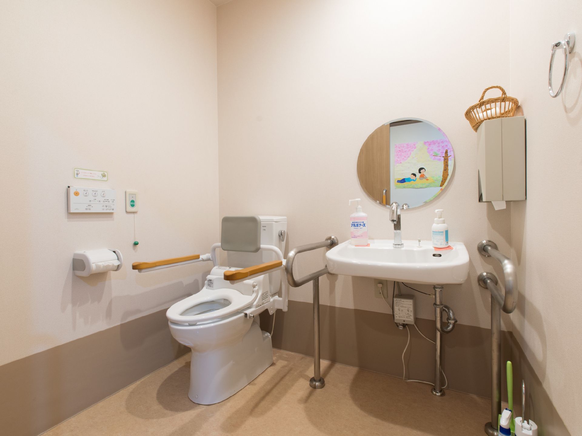 トイレでは、不要な作業負荷を省略するため、便座のフタを撤去してある。背もたれを代わりに設置し、また手すりも両側に設けて利便性を高めた。