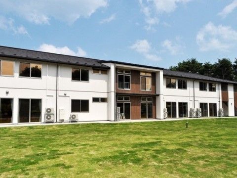 「サービス付き高齢者向け住宅 かっこうの森」の外観。木造２階建ての自然豊かで健やかな暮らしができる施設。