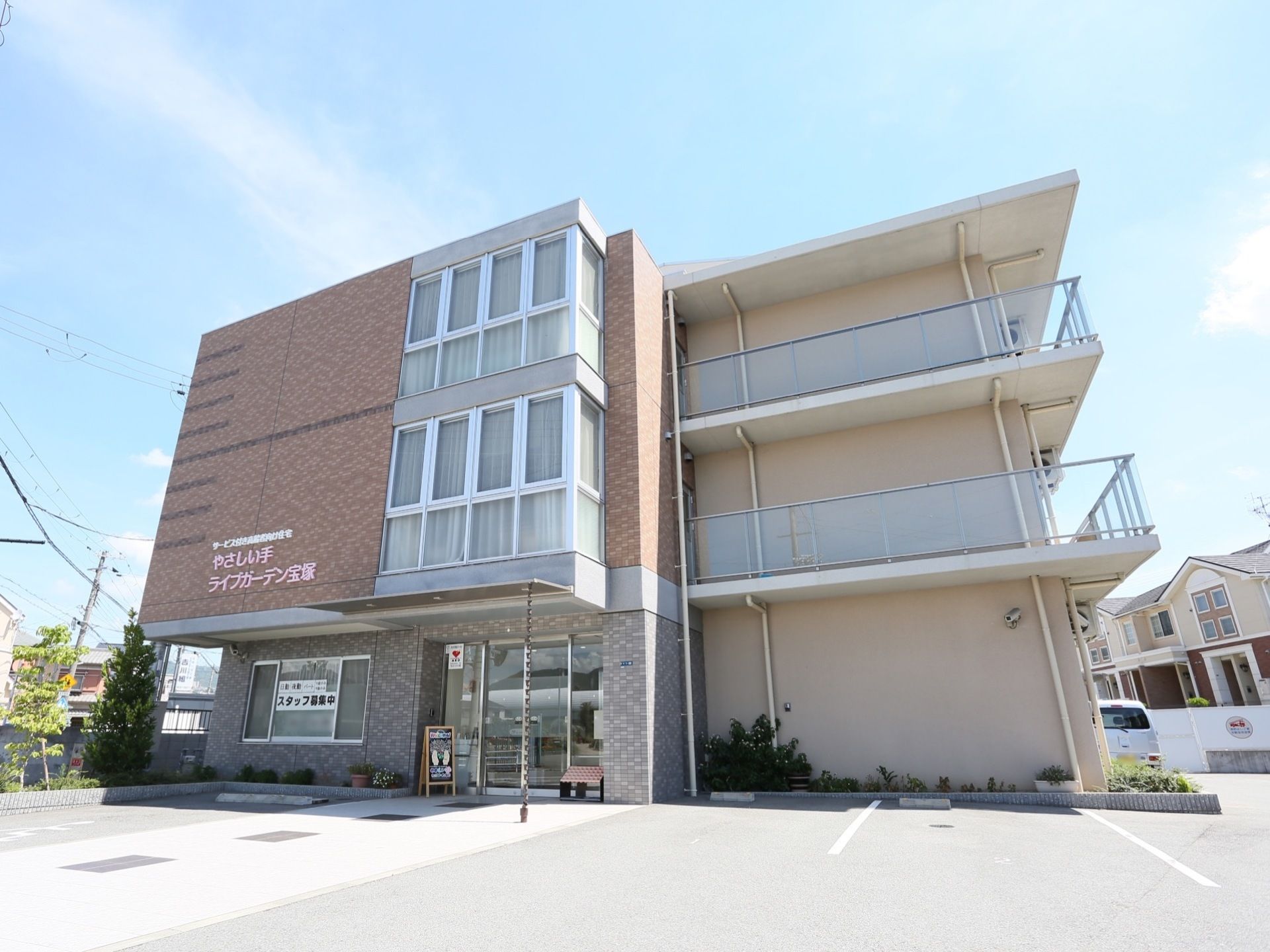 3階建ての鉄筋コンクリート製の建物で、施設の前には駐車スペースが設けられている。周囲には住宅が広がっている。