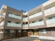 各階ベランダを完備した、茶色とベージュを基調としている3階建ての建物