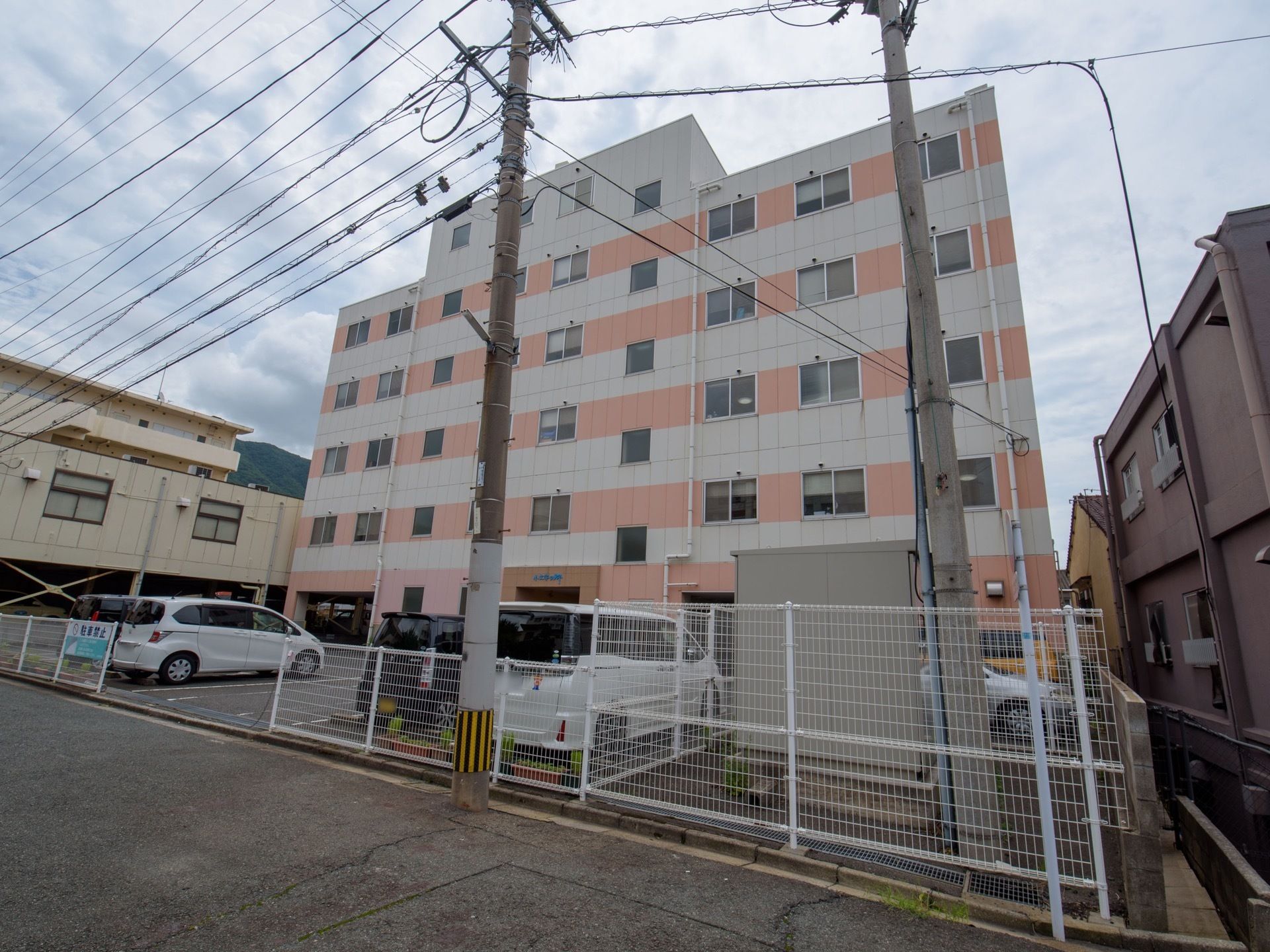 ５階、一部６階建ての四角い建物である。外壁は階ごとに、淡いオレンジと白色で交互に色が塗り分けられている。