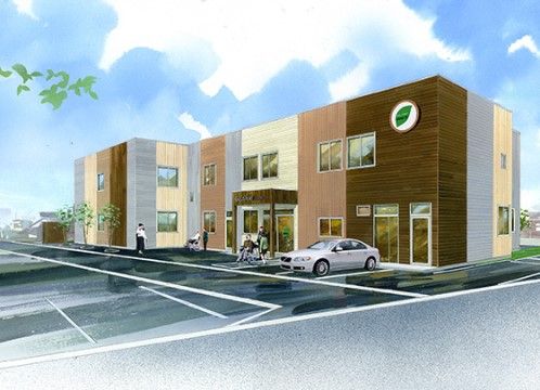 施設の建物は二階建てで、壁の色はブラウン系の濃淡となっている。敷地内は舗装され、駐車場が整備されている。