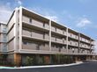 地上４階建ての施設は、分譲マンションのような洗練されたデザインである。日当たりの良い環境で、周囲には青空が広がっている。