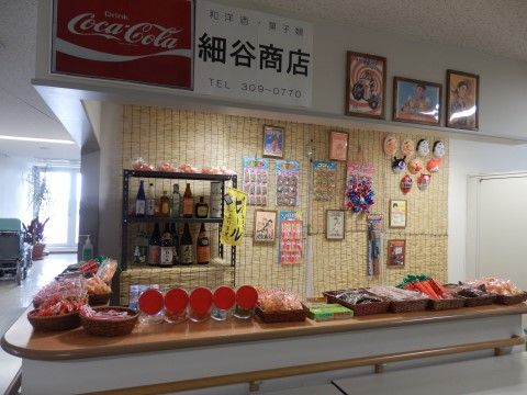 喫茶店のようなL字のカウンターがあり、その上にバスケットに入ったお菓子など、さまざまな物が並べられている。