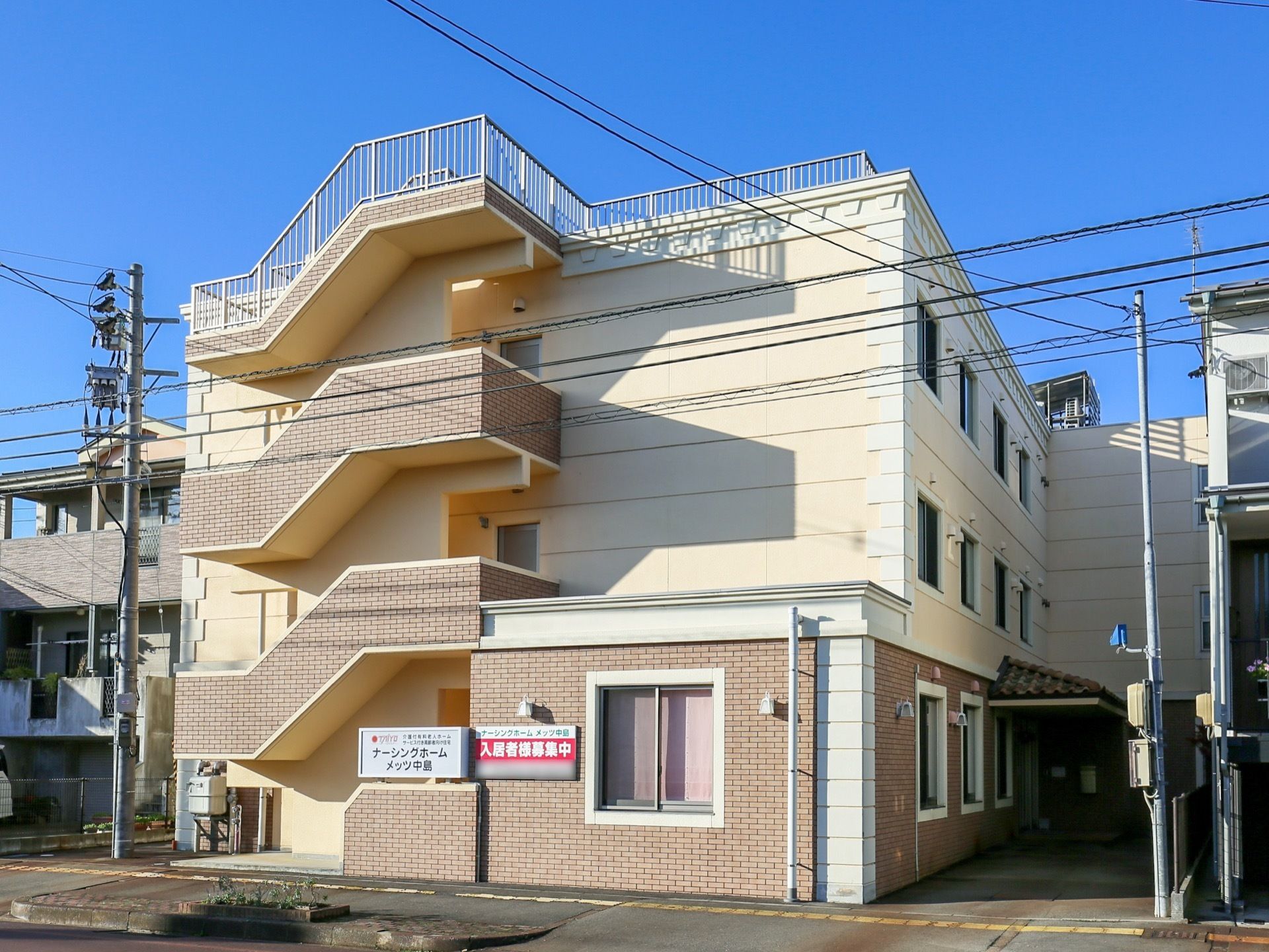 建物は3階建てになっていて、左側には外階段が付いている。屋上があり、まわりはフェンスで囲まれている。