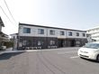 2階建てのシンプルな外観の施設の前には広いスペースがあり車を数台駐車できる。施設には非常用に外階段も設置してある。