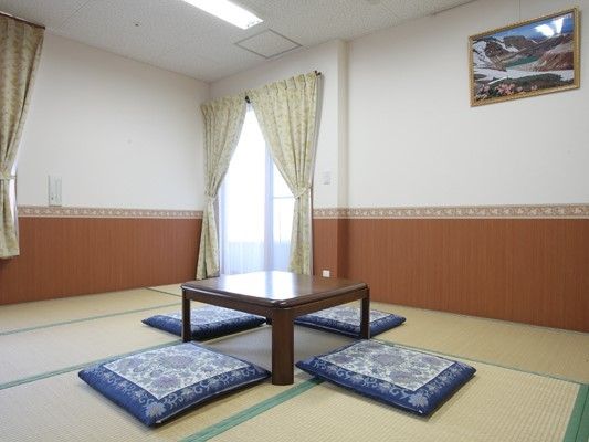 畳敷きの和室には中央にちゃぶ台が置かれ、座布団が囲むようにして4枚置かれている。