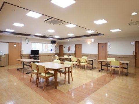 「応援家族 足立」のデイルーム。広々とした開放感のある共有スペース。