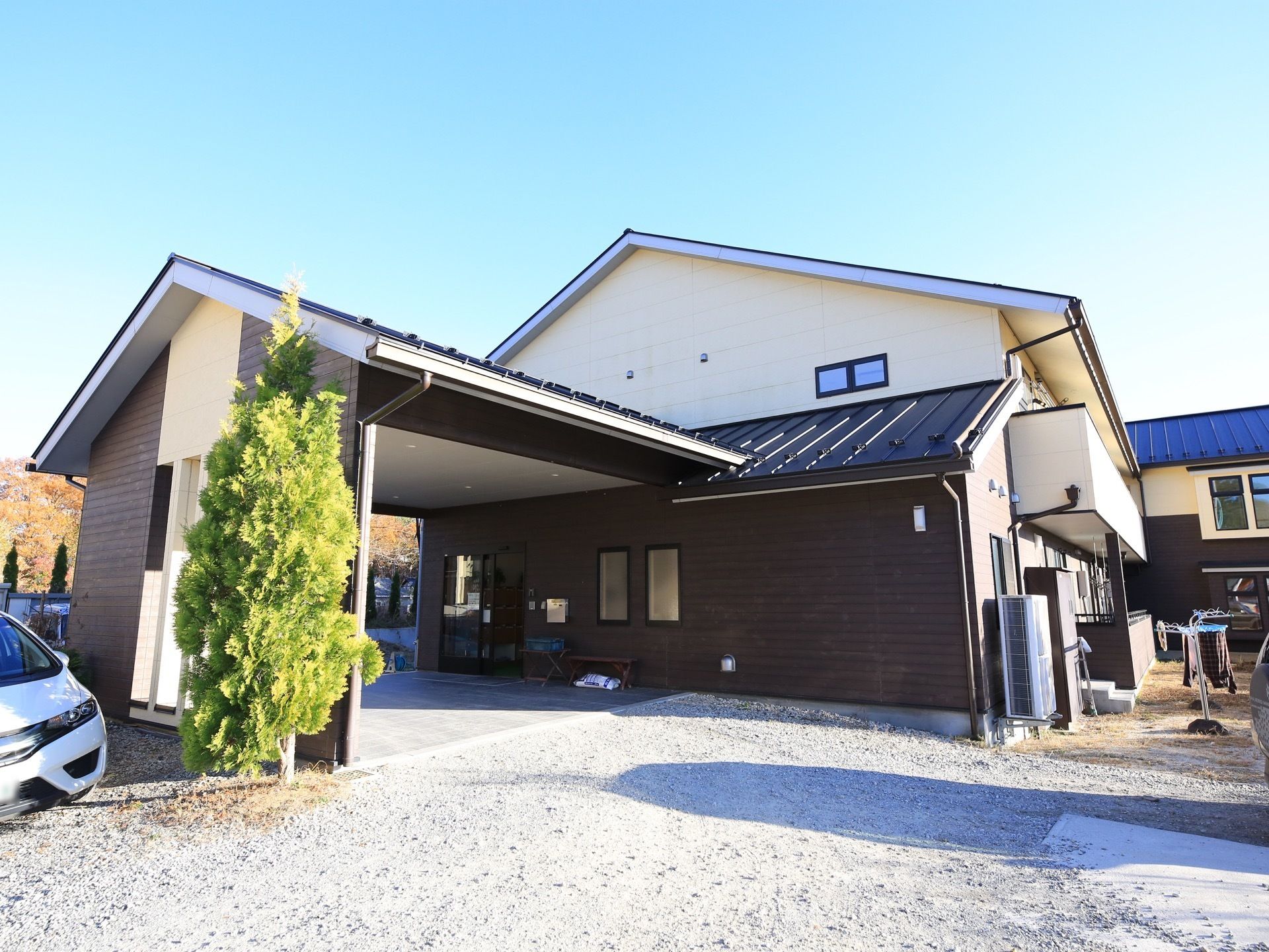 落ち着きのある濃い茶色の外観である。入口に向かって緩やかな傾斜がついている。車を施設の近くに停めることができる。