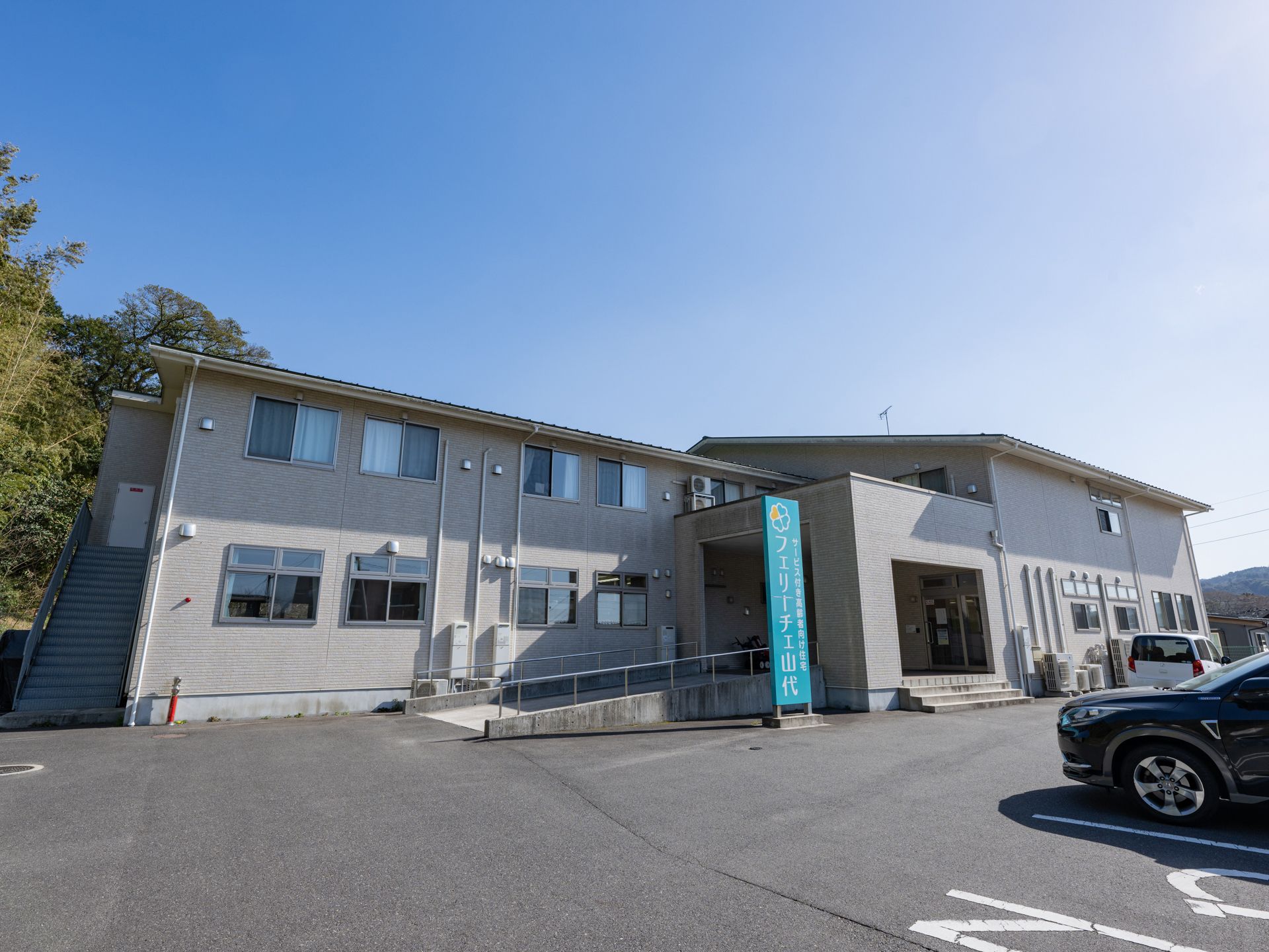 近隣に駐車場が設置されている介護施設の外観