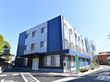 鉄骨ぞの建物の外観パース。スタイリッシュなデザインが印象的な施設