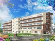 5階建ての建物は横に長く、白をメインとして明るい雰囲気。日当たりもよく、周囲には草木が植えられている。