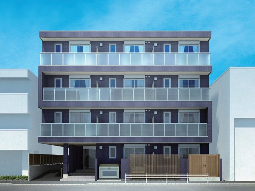 各フロアにベランダがある4階建ての建物。グレー系で1階部分にはフェンスのようなものがある。